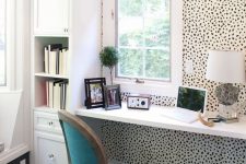 23 animal-printed wallpaper accentuates a small home office nook and brings pattern and a fun touch to the space