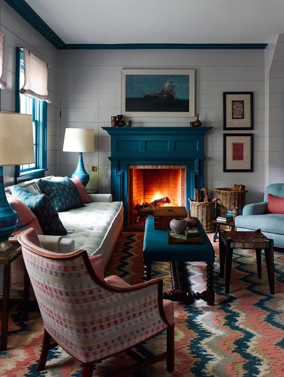 a teal fireplace is a natural solution for a coastal living room and other teal items echo with it perfectly creating a cohesive look