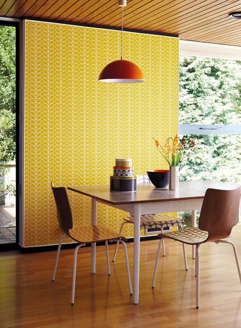 bold yellow and white printed retro sixties' wallpaper accentuates a breakfast nook and brings color and pattern here