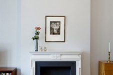 a French fireplace with large books inside that turn this fireplace into a lovely and unusual display
