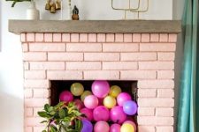 a blush brick fireplace with colorful balloons inside will make a cute girlish accent in your living room