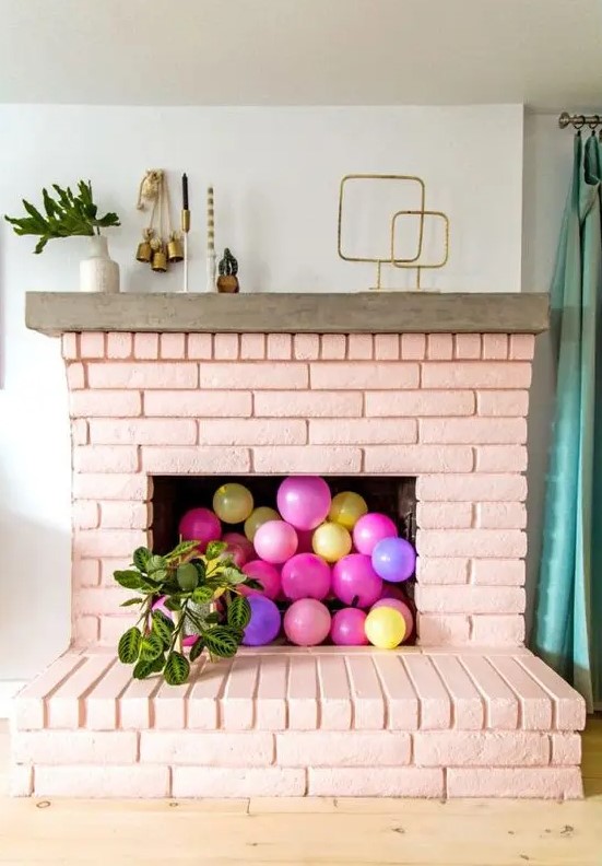 a blush brick fireplace with colorful balloons inside will make a cute girlish accent in your living room