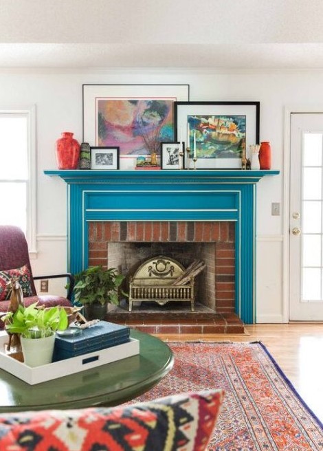 A bright mid century modern living room with a bold blue mantel over a red brick fireplace, the mantel completely changes the look