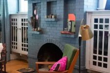 a dusty blue brick fireplace with decor and artwork is a stylish and cool decor idea for any pastel living room