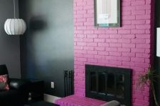 a moody living room accented with a purple brick fireplace and an artwork for a gorgeous statement