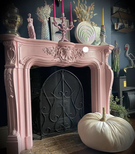 A non working fireplace with a pink vintage mantel and some bright decor on it is a gorgeous idea for a refined living room