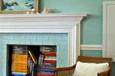a non-working fireplace with bright books inside is a cool solution to use a piece that doesn’t work