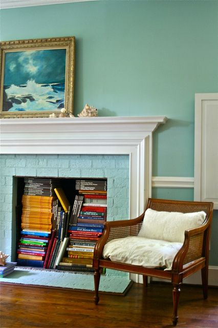 A non working fireplace with bright books inside is a cool solution to use a piece that doesn't work