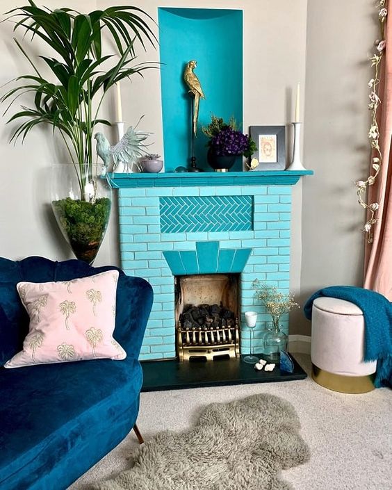 a refined living room with a fireplace clad with turquoise bricks, a turquoise mantel, a navy loveseat and a blush stool