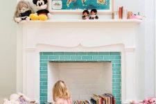 a vintage fireplace with a lovely white mantel, with turquoise tiles and colorful books stored inside it is a centerpiece of the room