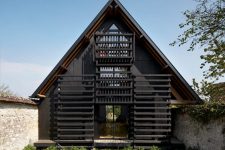01 This house in rural France was built between the walls of an existing one and was painted black for a modern feel