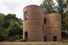 01 This unique house in Belgium is built of reclaimed bricks and is dotted with large windows here and there also featuring a gorgeous shape