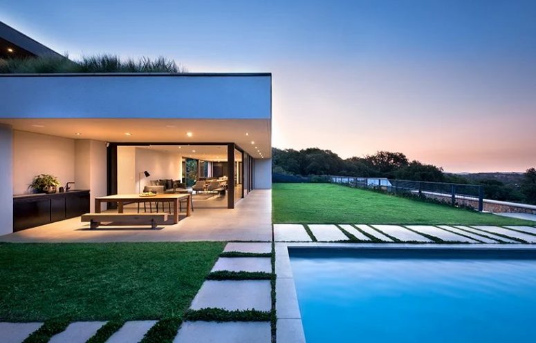 The house is built for outdoor-indoor living, there's a lawn terrace and a pool outside