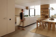 02 The large main layout is flooded with natural light, there’s wooden and white furniture