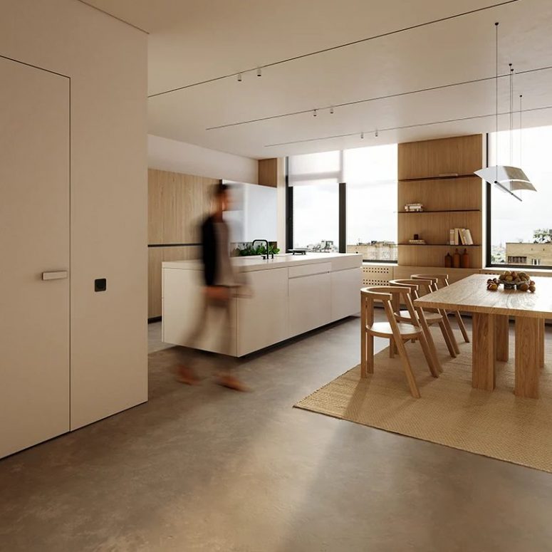 The large main layout is flooded with natural light, there's wooden and white furniture