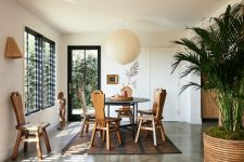 06 The dining space is maked with a geometric table and vintage wooden chairs