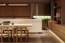 08 The kitchen shows off sleek cabinetry and a white kitchen island plus elegant lightting