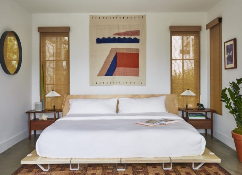 The master bedroom is done with bold touches, comfortable mid-century modern furniture and burlap shades