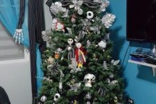 a Christmas tree decorated with Nightmare Before Christmas ornaments and with Jack Skellington standing next to it