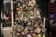 a Christmas tree with lights, Nightmare Before Christmas ornaments, striped ribbons, shiny branches and twigs and a hat on top