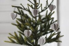 a Nordic tabletop Christmas tree in a pot decorated with grey and white 3D cardboard ornaments is a pretty and eco-friendly idea