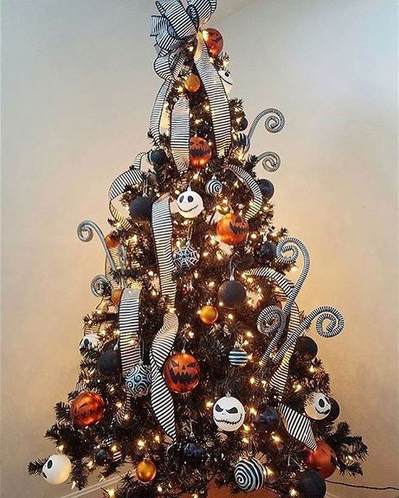 a black Christmas tree with lights, orange, black and white ornaments and Jack Skellington ones, striped ribbons and curls