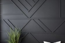 a black geometric paneled wall is a cool solution for a boho, mid-century modern and just elegant contemporary space