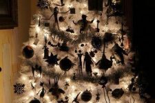 a lit up white Christmas tree with Nightmare Before Christmas ornaments and garlands is a lovely idea