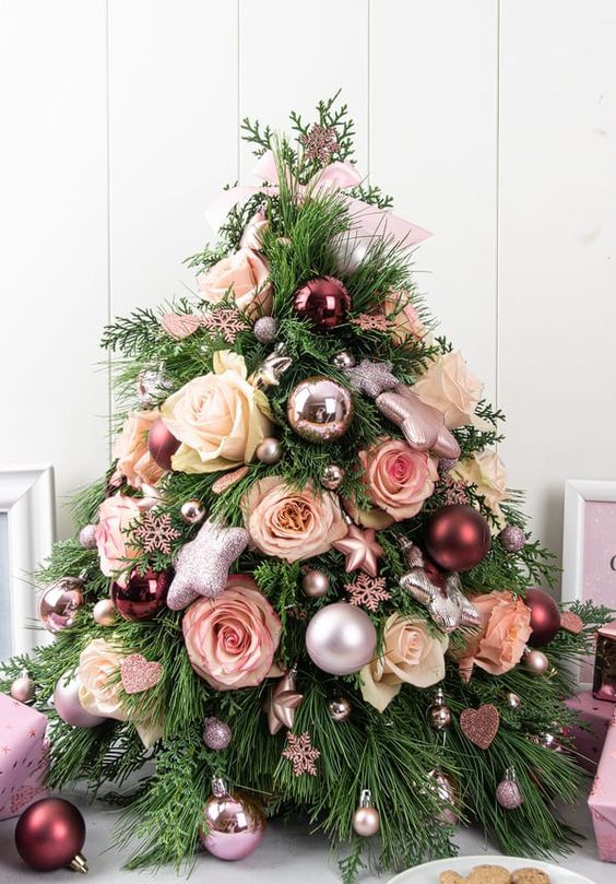 a lovely tabletop Christmas tree with blush and white roses, metallic ball and star ornaments and snowflakes is fabulous