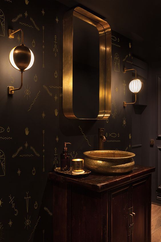a refined bathroom with black walls and a single statement wallpaper wall with Egyptian hieroglyph prints is wow