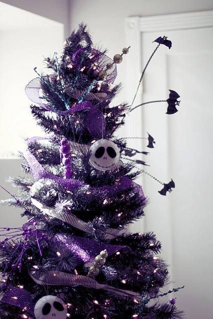 a shiny purple Christmas tree with lights, bats, beads and sheer Skellington ornaments is a bold solution for Christmas