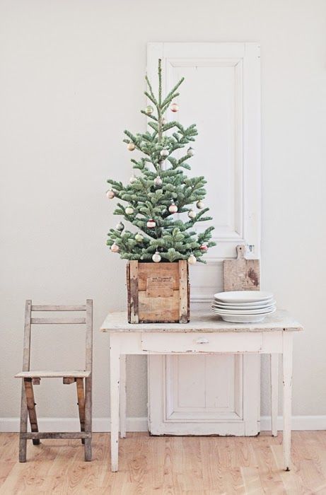 a tabletop Christmas tree in a wooden box and with pastel color block otnaments feels a bit retro and a bit rustic