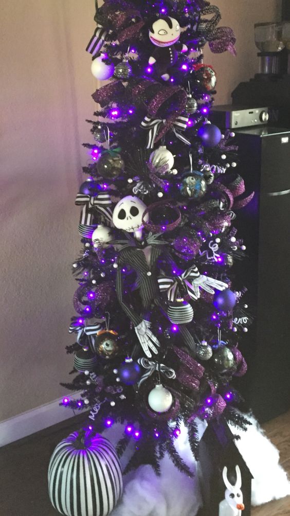 a tall black Christmas tree with purple ornaments, striped bows, Jack Skellington ornaments is gorgeous