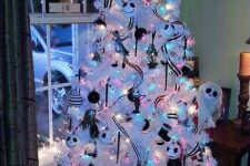 a white Christmas tree with colorful lights, black and white ribbons and ornaments, Jack Skellington ones, bows and garlands