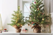 pretty tabletop Christmas trees – one decorated with lights, another one with small colorful ornaments and lights