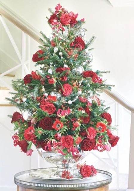 unique tabletop Christmas tree decor done with red berries, red and burgundy blooms and some silver ornaments is chic and glam