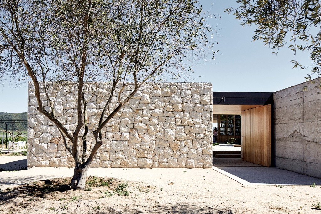 White stone walls enclose the four volumes, of which the house consists