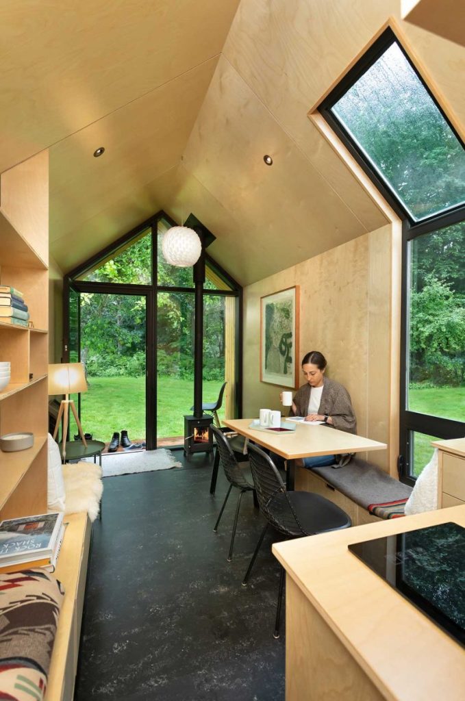 The inside of the house is done with light-colored plywoood and enjoys much natural light
