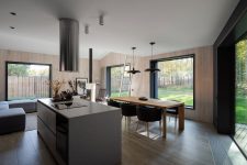 04 The main space is comprised of three parts – a kitchen, a dining room and a sitting zone, with stylish minimalist furniture and gorgeous unbstructed views