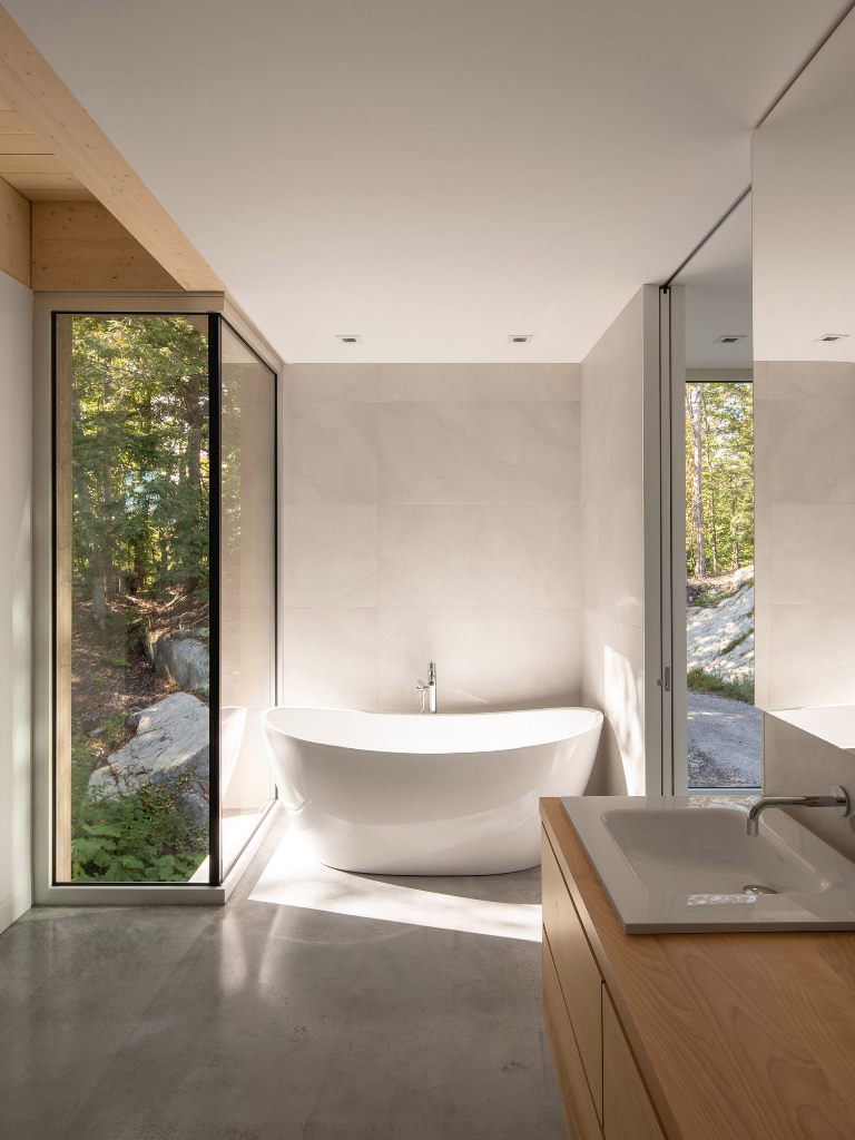 The master bathroom features a bath tub with a view