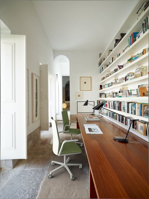 a home office with open shelves over the desk that allow organizing and don't look bulky