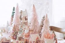 a blush Christmas tablescape with cone trees, a gnome and gingerbread houses, pink plates and gold cutlery