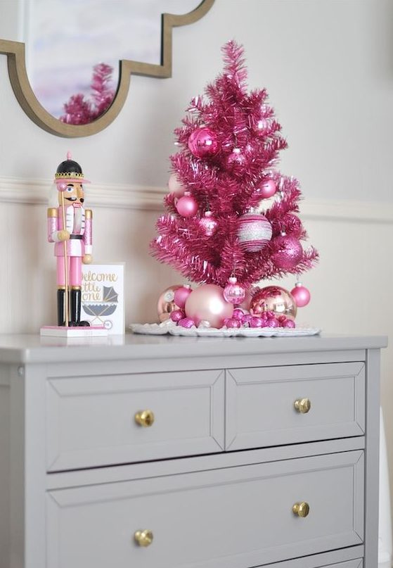a bold tabletop pink tree with ornaments will be a cute idea for any room