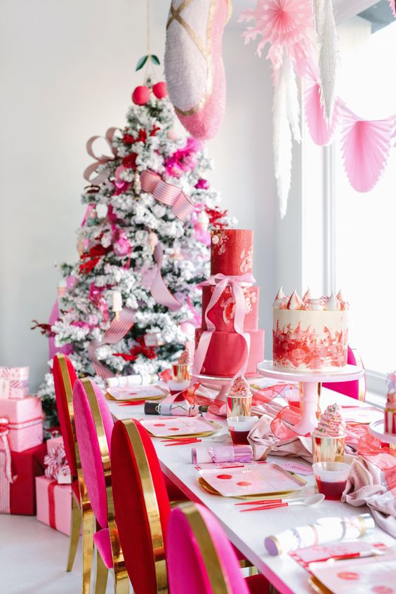 a bright Christmas space decorated in red, pink and gold, with paper fans, ribbons and ornaments is a bold idea
