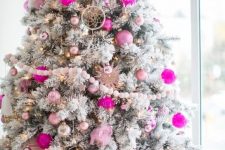a flocked Christmas tree with silver, light and hot pink ornaments, dream catchers and lights is amazing for the holidays