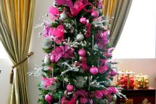 a glam Christmas tree with hot pink and fuchsia ornaments and fabric blooms, silver twigs, beads and lights is a bright idea