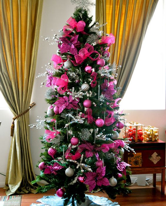 a glam Christmas tree with hot pink and fuchsia ornaments and fabric blooms, silver twigs, beads and lights is a bright idea