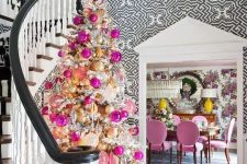 a glam flocked Christmas tree decorated with lots of hot pink, pink, gold and champagne ornaments and lights