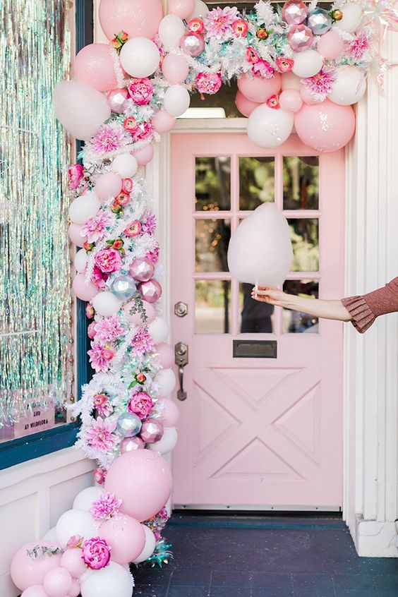 a lovely pink Christmas garland of balloons, pink ornaments, faux blooms and some greenery is a beautiful idea