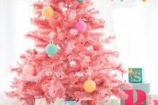 a pastel pink Christmas tree decorated with pastel pink, yellow, aqua and purple ornaments is a very cute and sweet idea